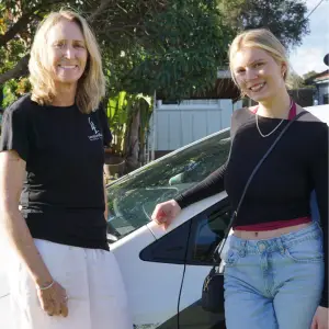 Jess learning 4 life standing beside car